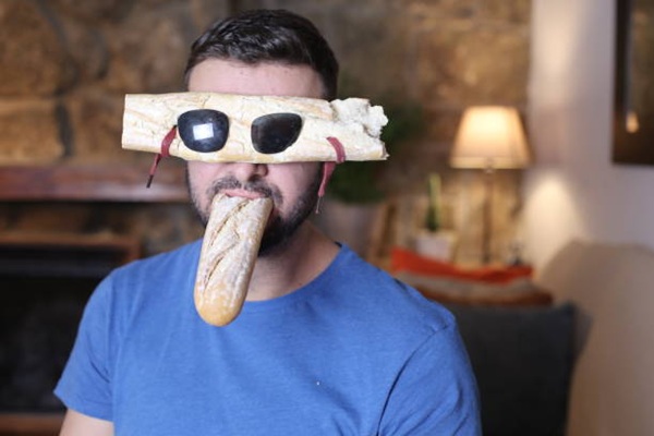 Man wearing bizarre bread sunglasses.