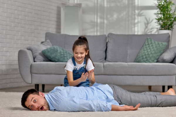 happy little child daughter doing massage to father at home. Father's day. happy little child daughter doing massage to father at home. Father's day.