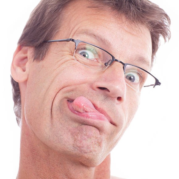 Man with glasses sticking tongue out
