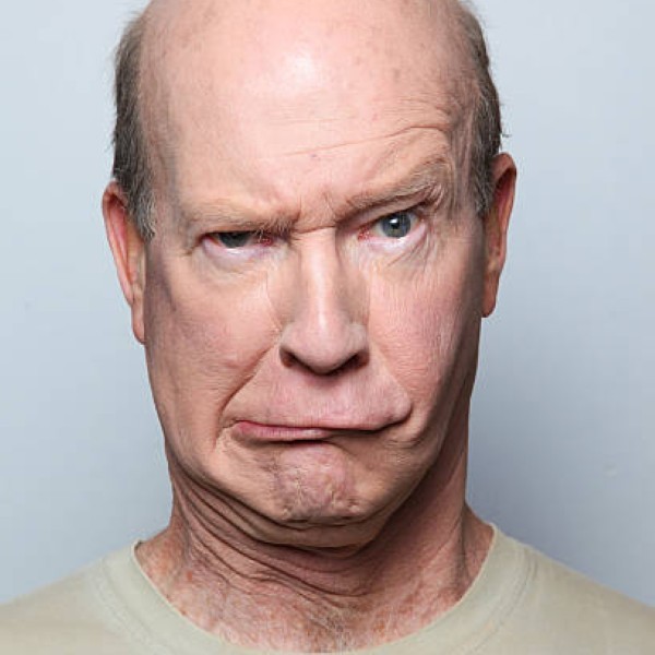 Man making funny face and grimacing