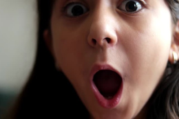 Girl looks and is surprised and happy to receive a surprise.