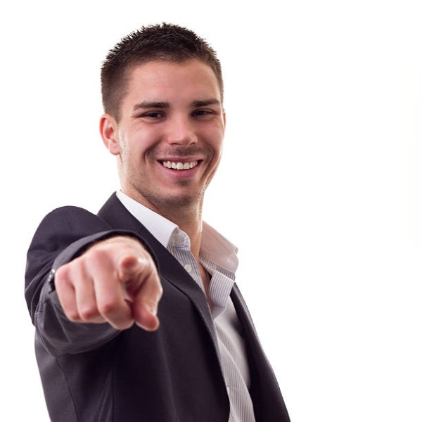 Smiling young man pointing at the camera, isolated on white