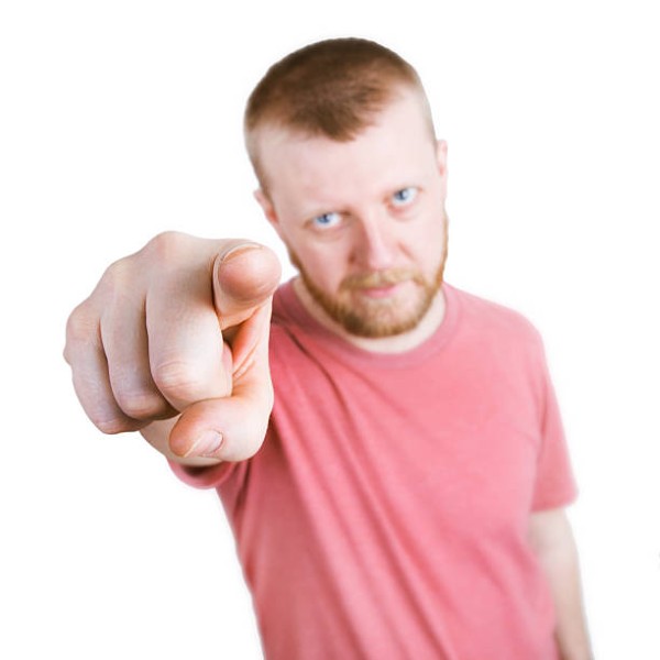 Bearded man points his index finger at the camera
