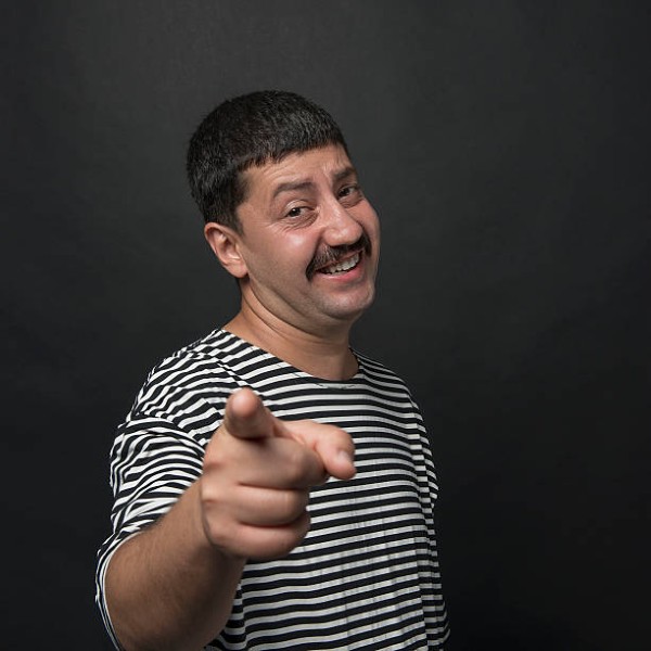 Man pointing with content smile