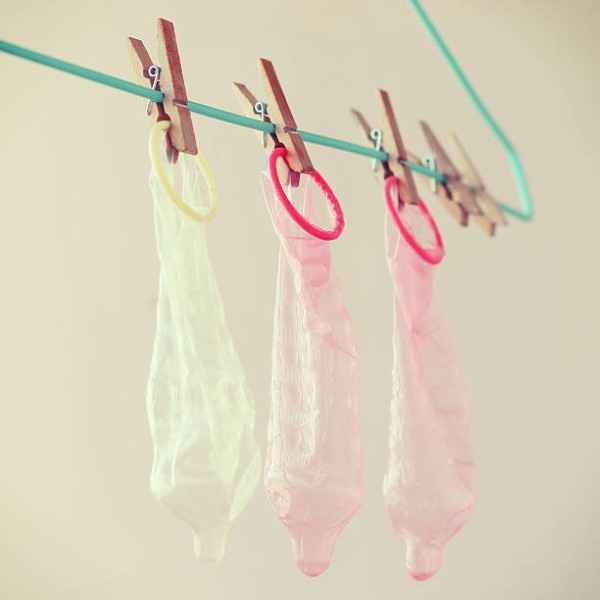 Clothespin and a condom. Recycling concept humor, vintage tone